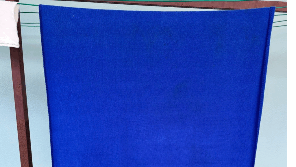 Blue microfiber cloth air-drying on a line to protect the fibers