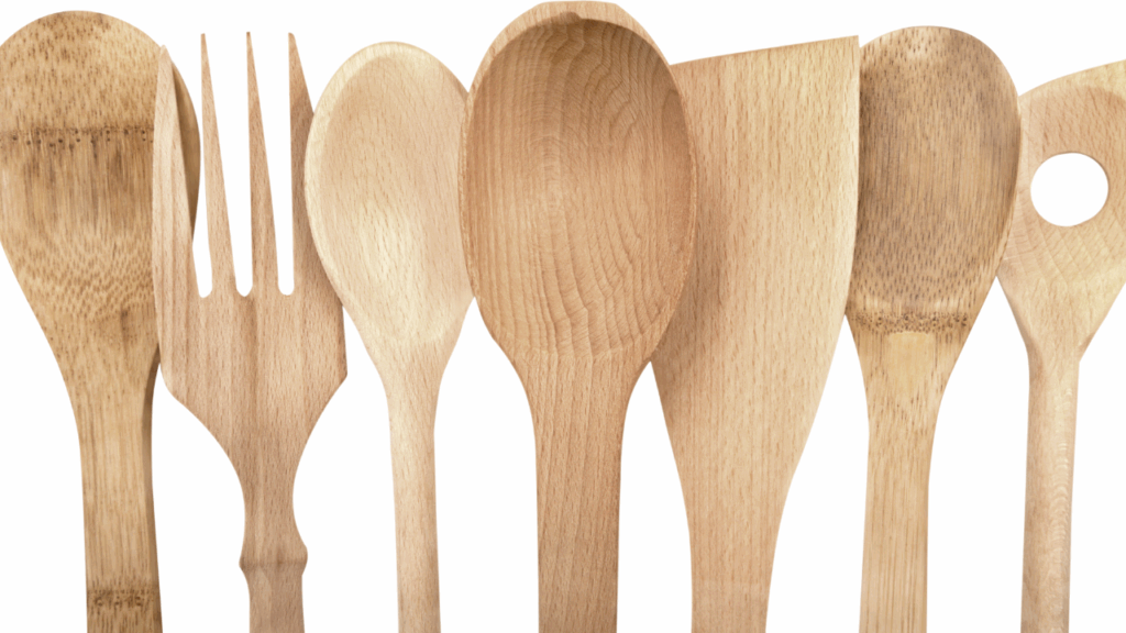 wooden kitchen utensils lined up clean and dry