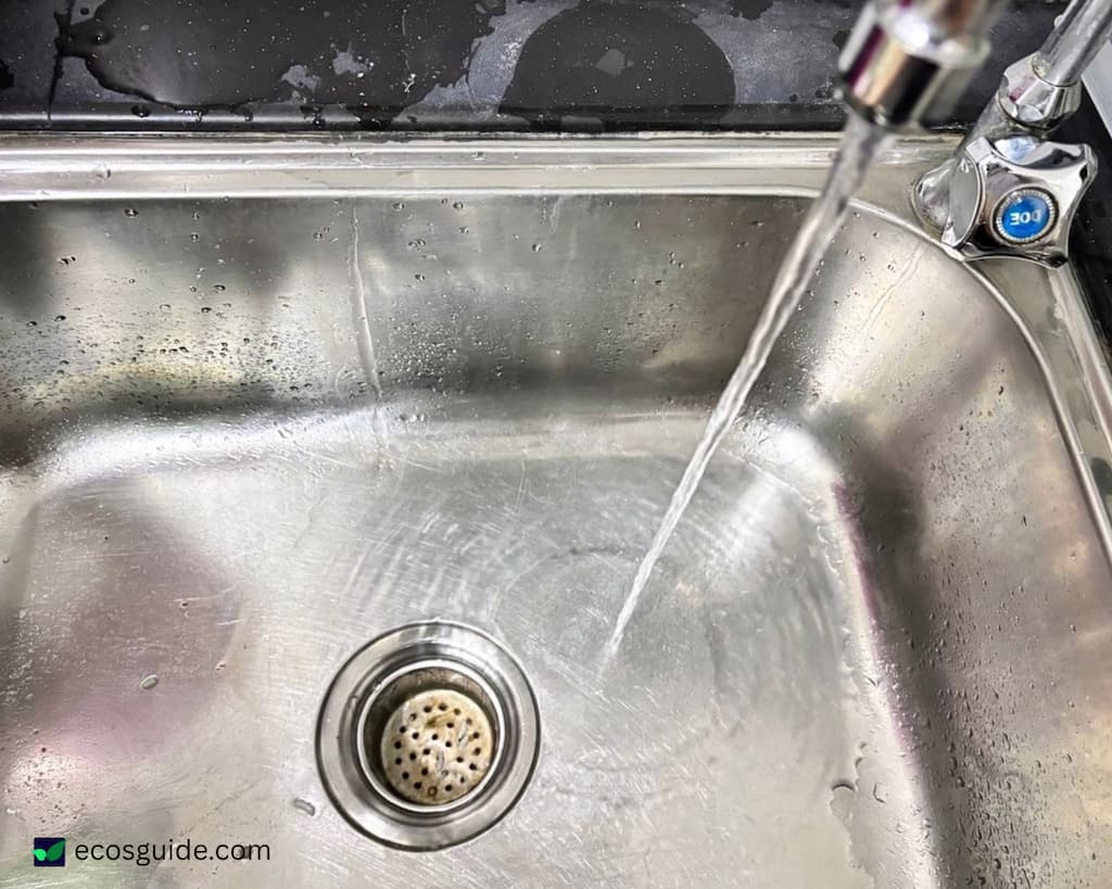 detergent chemicals and synthetic sponge fibres flowing down the kitchen drain